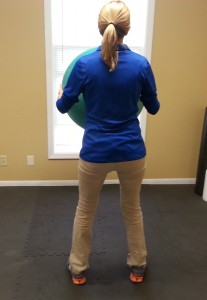 Dr. Kadi Fletcher demonstrating medicine ball exercises from behind