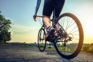 Cyclist rides with sunset in background