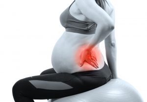 Pregnant woman with sever back pain, painful area is highlighted in red