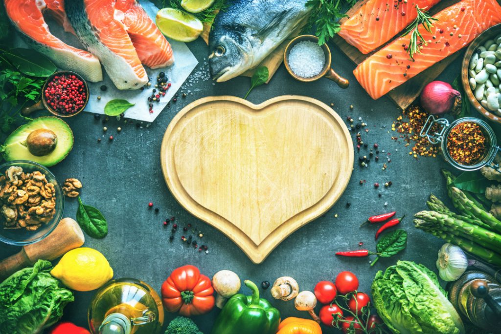 Assortment of fresh fish with aromatic herbs, spices and vegetables. Balanced diet or cooking concept